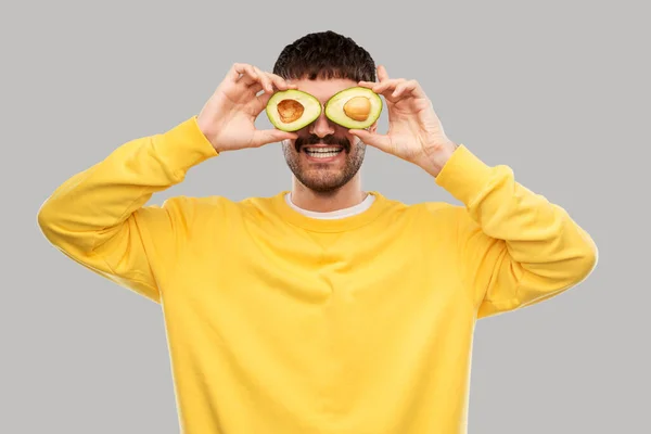 Šťastný mladý muž s avokádem místo očí — Stock fotografie