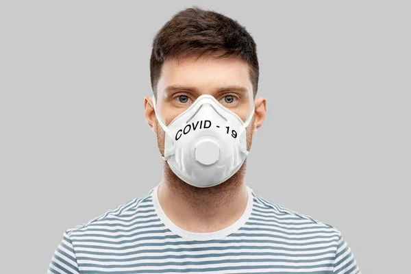 Young man in face protective mask or respirator — Stock Photo, Image