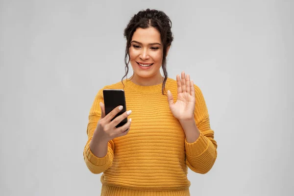 Happy young woman having video call on smartphone — Stock Photo, Image