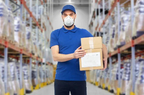 Delivery man in mask or respirator at warehouse — Stock Photo, Image