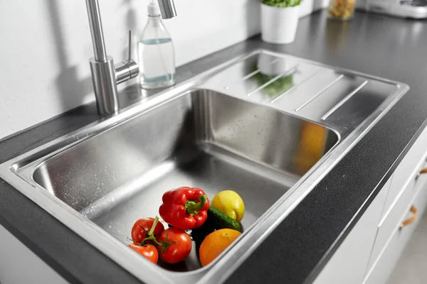 fruits and vegetables in kitchen sink