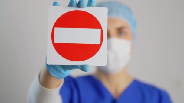 Doctor or nurse in face mask showing stop sign — Stock Video