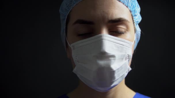 Sad female doctor or nurse in medical face mask — Stock Video