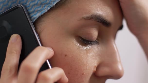 Плачущий врач или медсестра звонит на смартфон — стоковое видео