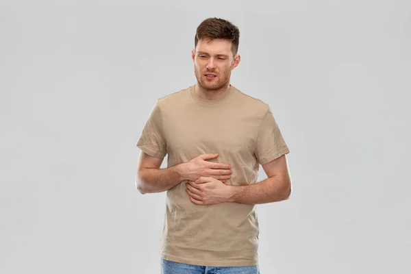 Unhappy man suffering from stomach ache — Stock Photo, Image
