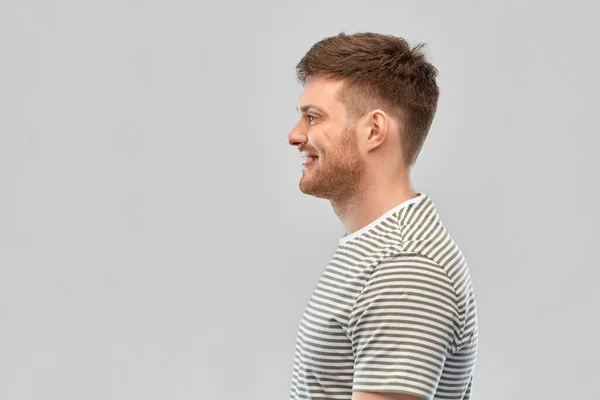 Smiling young man in striped t-shirt — Stock Photo, Image