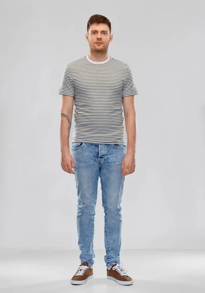 Young man in striped t-shirt — Stock Photo, Image