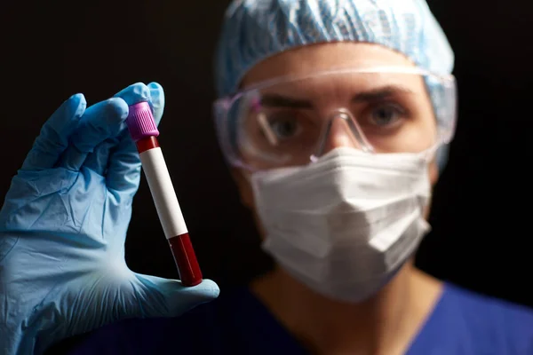 Primer plano del médico sosteniendo el vaso de precipitados con análisis de sangre —  Fotos de Stock