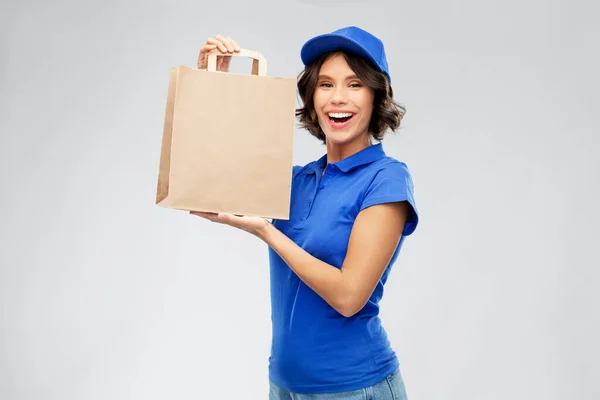 Delivery woman with takeaway food in paper bag — Stock Photo, Image