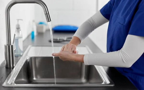 Doctor or nurse washing hands with liquid soap — Stock Photo, Image