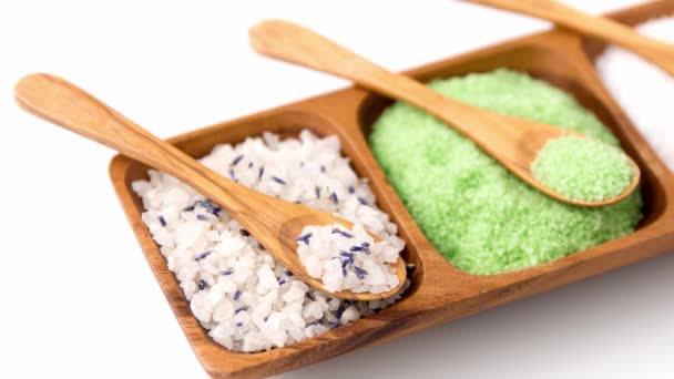 Different bath salts with wooden spoons on tray — Stock Video