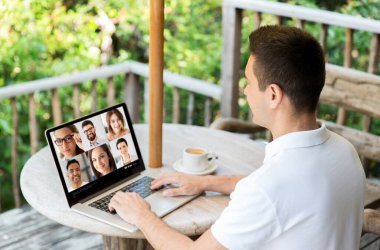 man with laptop having video call with colleagues clipart