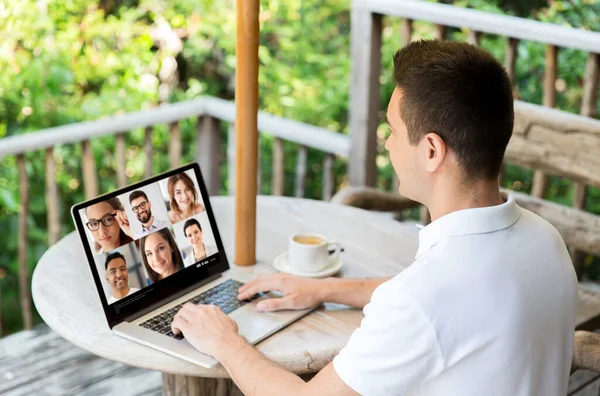 Man with laptop having video call with colleagues — Stock Photo, Image