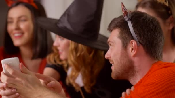 Friends in halloween costumes with smartphone — Stock Video