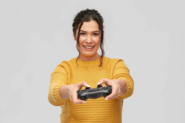 Happy young woman with gamepad playing video game — Stock Photo, Image