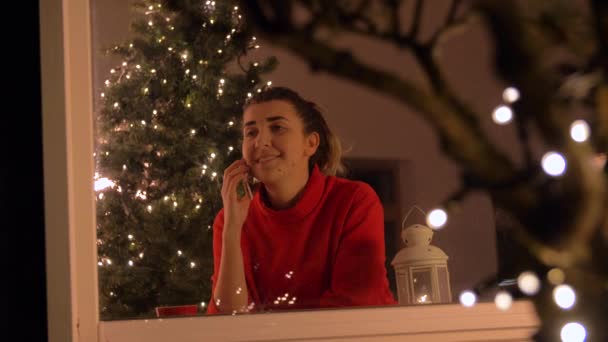 Mujer llamando en el teléfono inteligente en Navidad en casa — Vídeos de Stock