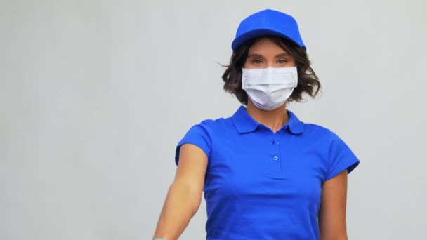 Delivery woman in mask holding paper bag with food — Stock Video