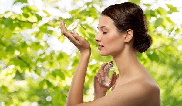 Happy woman smelling perfume from her wrist — Stock Photo, Image