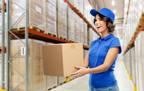 happy delivery girl with parcel box at warehouse