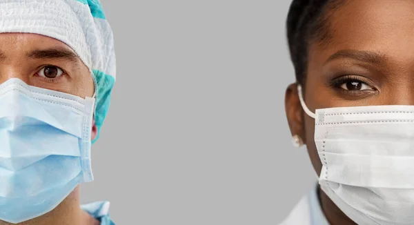 Close up of doctors in protective medical masks — Stock Photo, Image