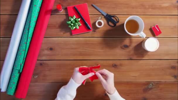 Händer inslagning jul gåva och skriva lapp — Stockvideo