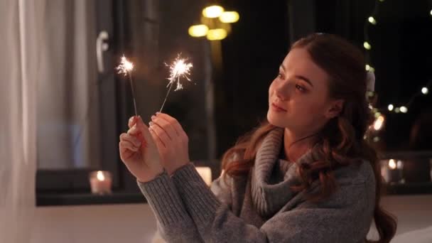 Heureuse jeune femme avec des étincelles à la maison — Video