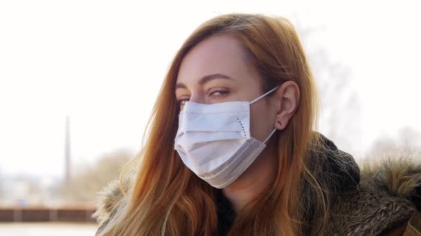 Νεαρή γυναίκα που φοράει προστατευτική ιατρική μάσκα — Αρχείο Βίντεο