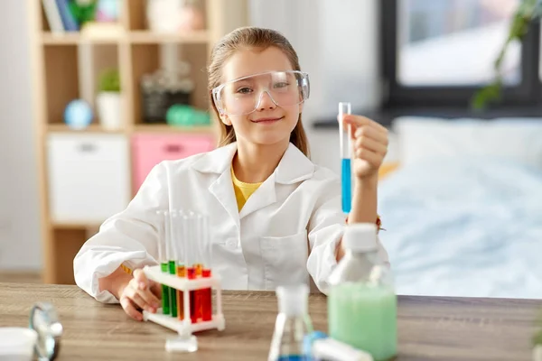 Menina com tubo de ensaio estudar química em casa — Fotografia de Stock