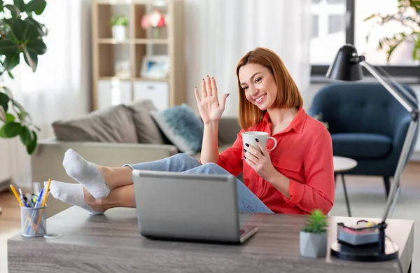 Femme avec ordinateur portable ayant un appel vidéo au bureau à la maison — Photo