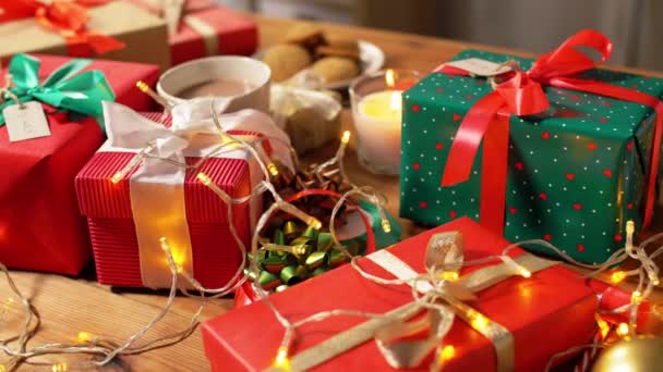 Noel hediyeleri, mum ve çelenk ışıkları evde. — Stok video