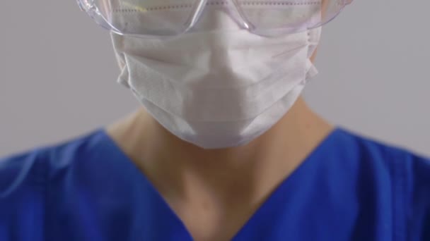Female doctor or nurse in goggles and face mask — Stock Video