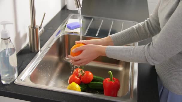 Mulher lavando frutas e legumes na cozinha — Vídeo de Stock