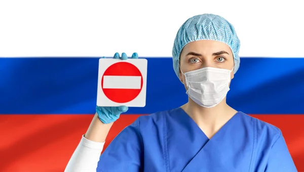 Russian doctor or nurse in mask showing stop sign — Stock Photo, Image