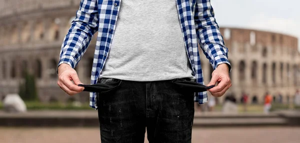 Close up of man showing empty pockets in italy — Stock Photo, Image