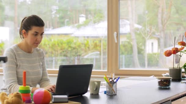 Young woman with laptop working at home office — Stock Video