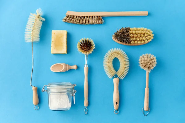 cleaning brushes and soda powder with scoop in jar