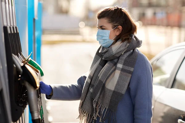 Mujer joven con máscara médica en la gasolinera — Foto de Stock
