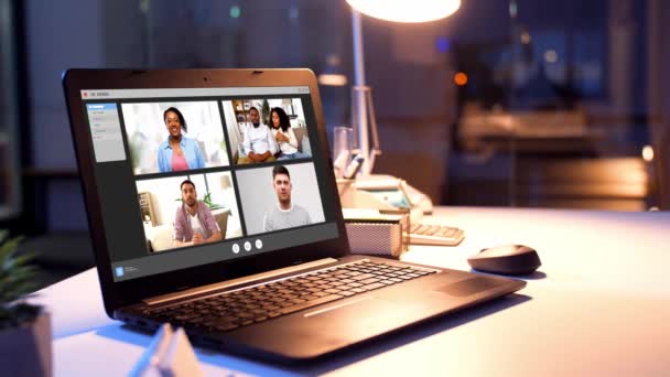 Group video chat windows on laptop at night office — Stock Video