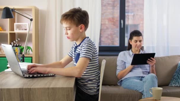 Student boy with laptop learning online at home — Stock Video