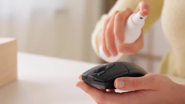 Close up of woman cleaning computer mouse — Stock Video