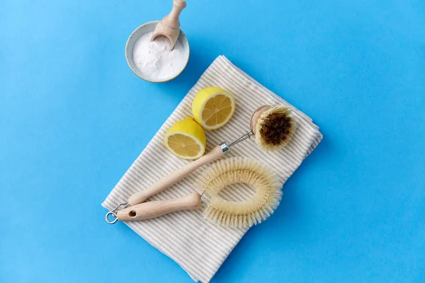 Cleaning brushes, lemon and washing soda on cloth — Stock Photo, Image