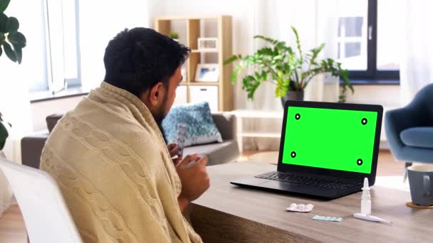 Sick man with medicine having video call on laptop — Stock Video