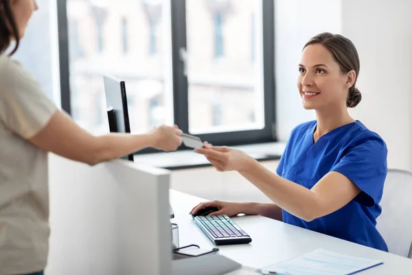 Doctor and patient with credit card at hospital — Stock Photo, Image