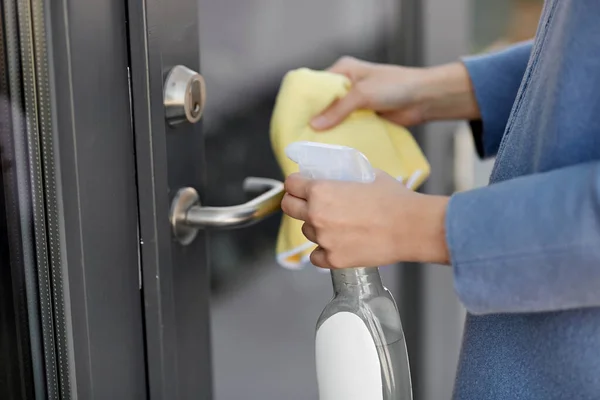 Manija de la puerta de limpieza a mano con detergente y trapo —  Fotos de Stock