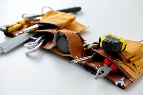 different work tools in belt on white background