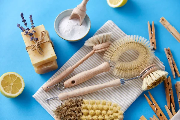 Cleaning brushes, lemon and wooden clothespins — Stock Photo, Image