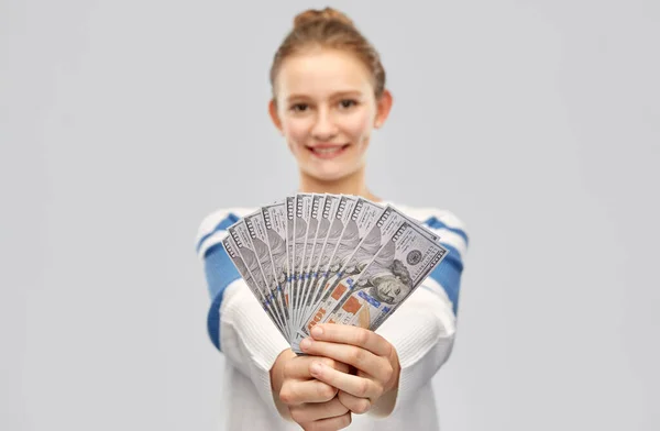 Smiling teenage girl with dollar money banknotes — Stock Photo, Image