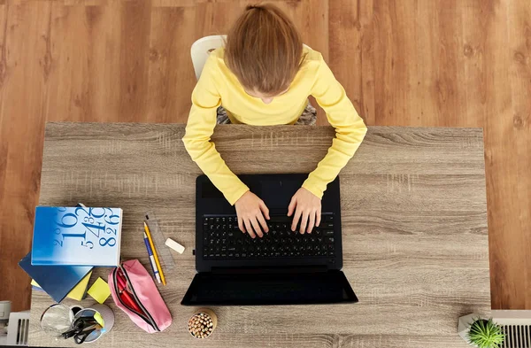 Chica estudiante sonriente escribiendo en el ordenador portátil en casa — Foto de Stock