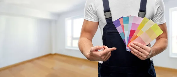 Close up of painter with color charts — Stock Photo, Image