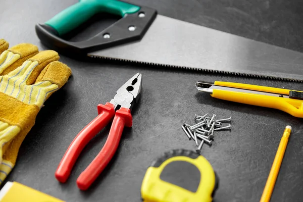 Different work tools on slate background — Stock Photo, Image